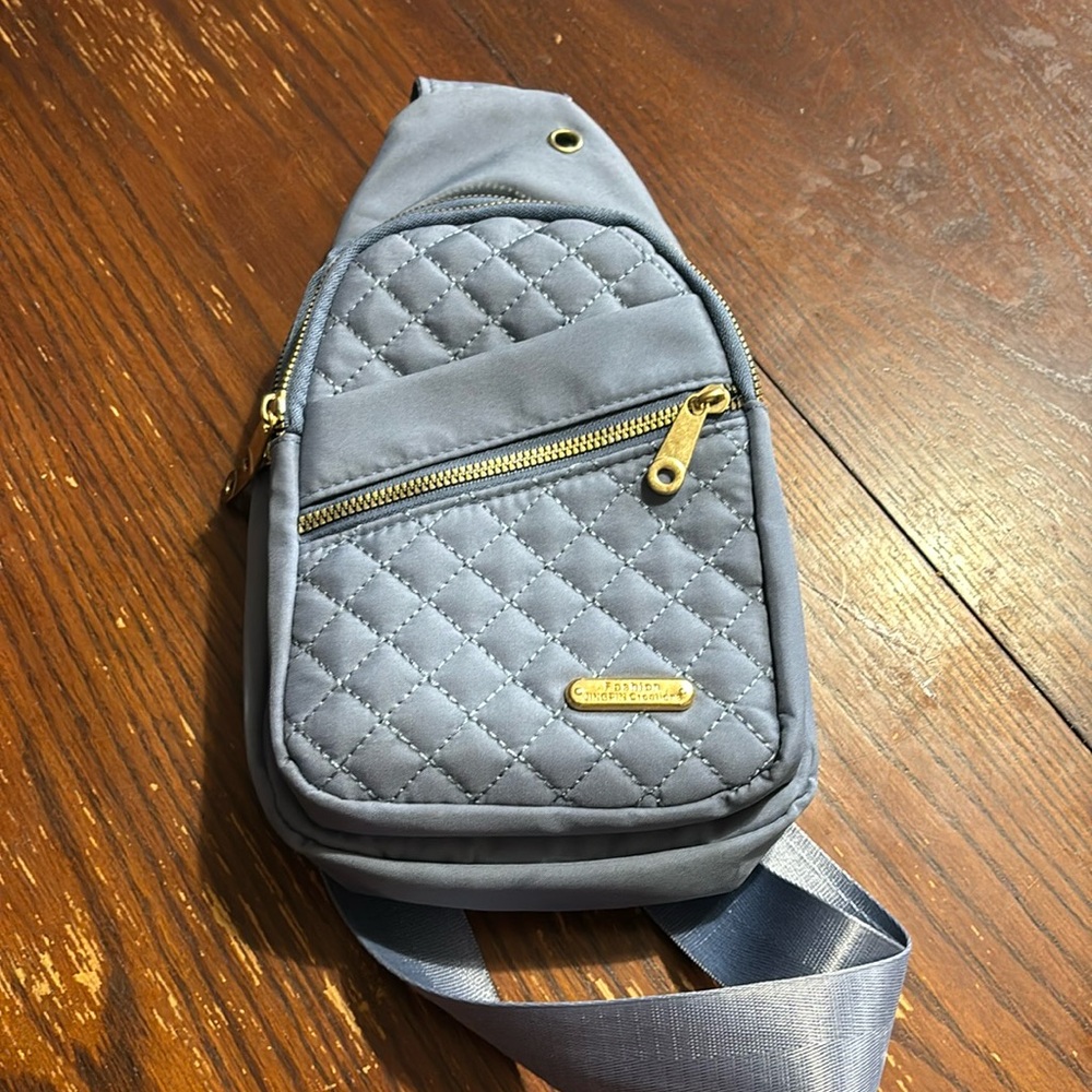 Slate blue with gold zippers. Almost new.  Barley used. Plus size crossbody